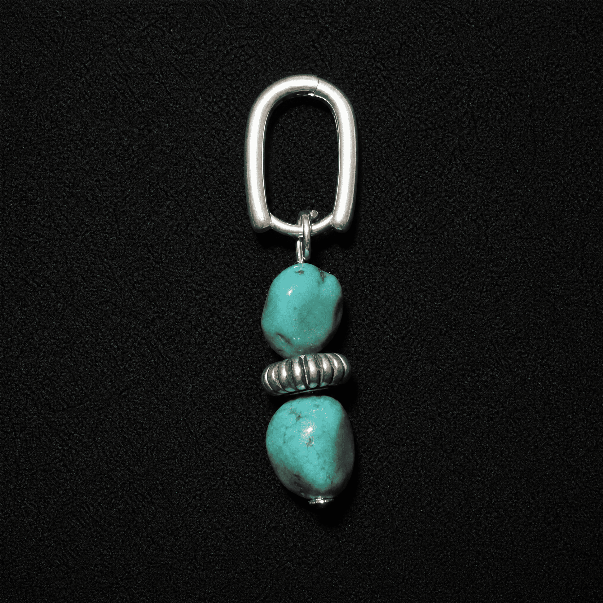 Artisan heritage style S925 silver hoop earrings featuring raw turquoise nuggets, displayed on a textured neutral fabric