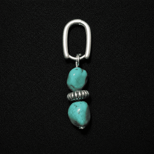 Artisan heritage style S925 silver hoop earrings featuring raw turquoise nuggets, displayed on a textured neutral fabric