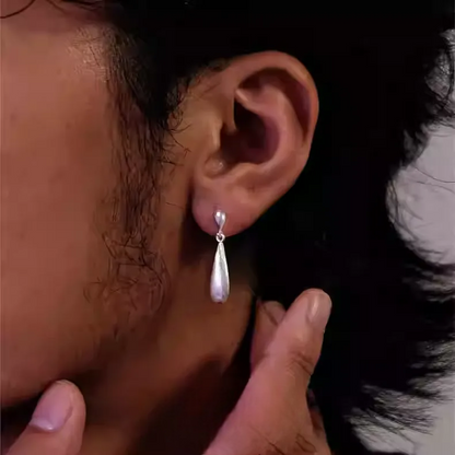 Brushed 925 Sterling Silver Teardrop Earrings Matte Waterdrop Dangles worn on ear with smooth brushed matte finish and sleek design