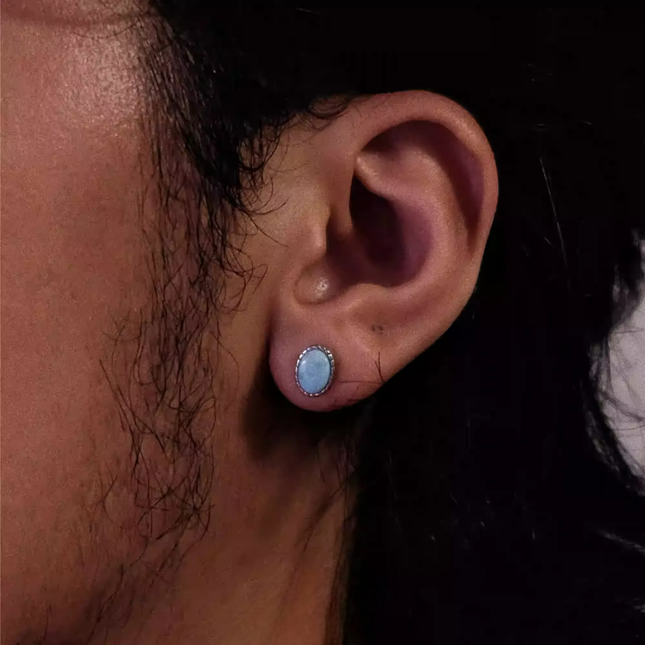Genuine Blue Larimar Earrings S925 Silver Round Gemstone Studs with delicate Tibetan-inspired silver bezel on ear close-up