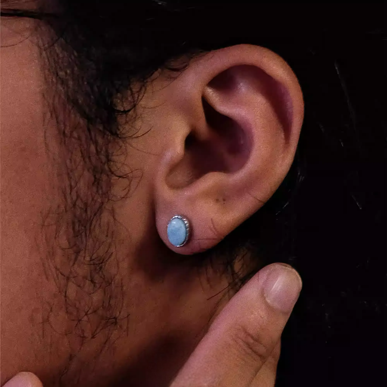 Genuine Blue Larimar Earrings S925 Silver Round Gemstone Studs worn on ear with delicate silver setting and natural stone texture
