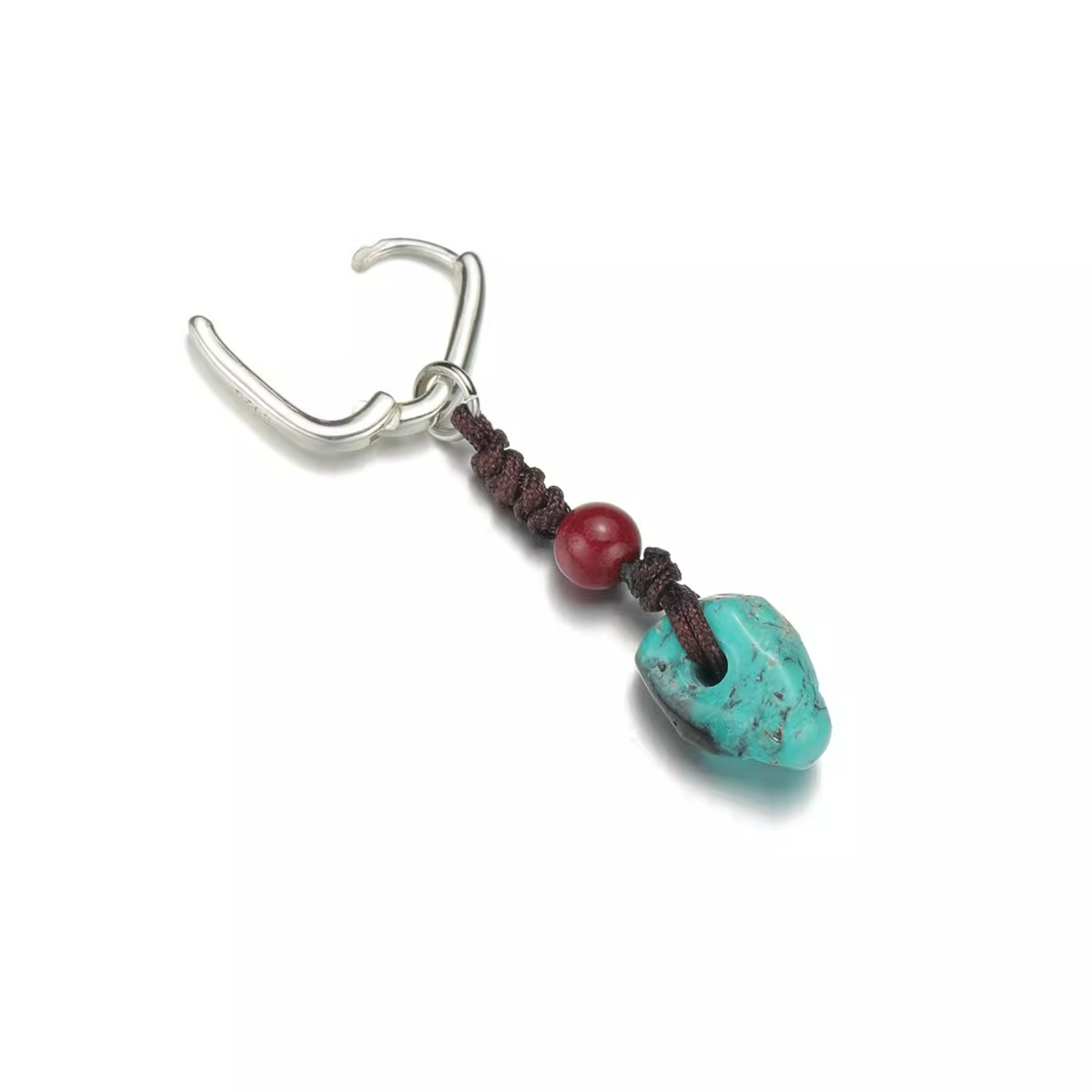 Silver hoop earring with a hand-knotted cord, red bead, and turquoise dangle.
