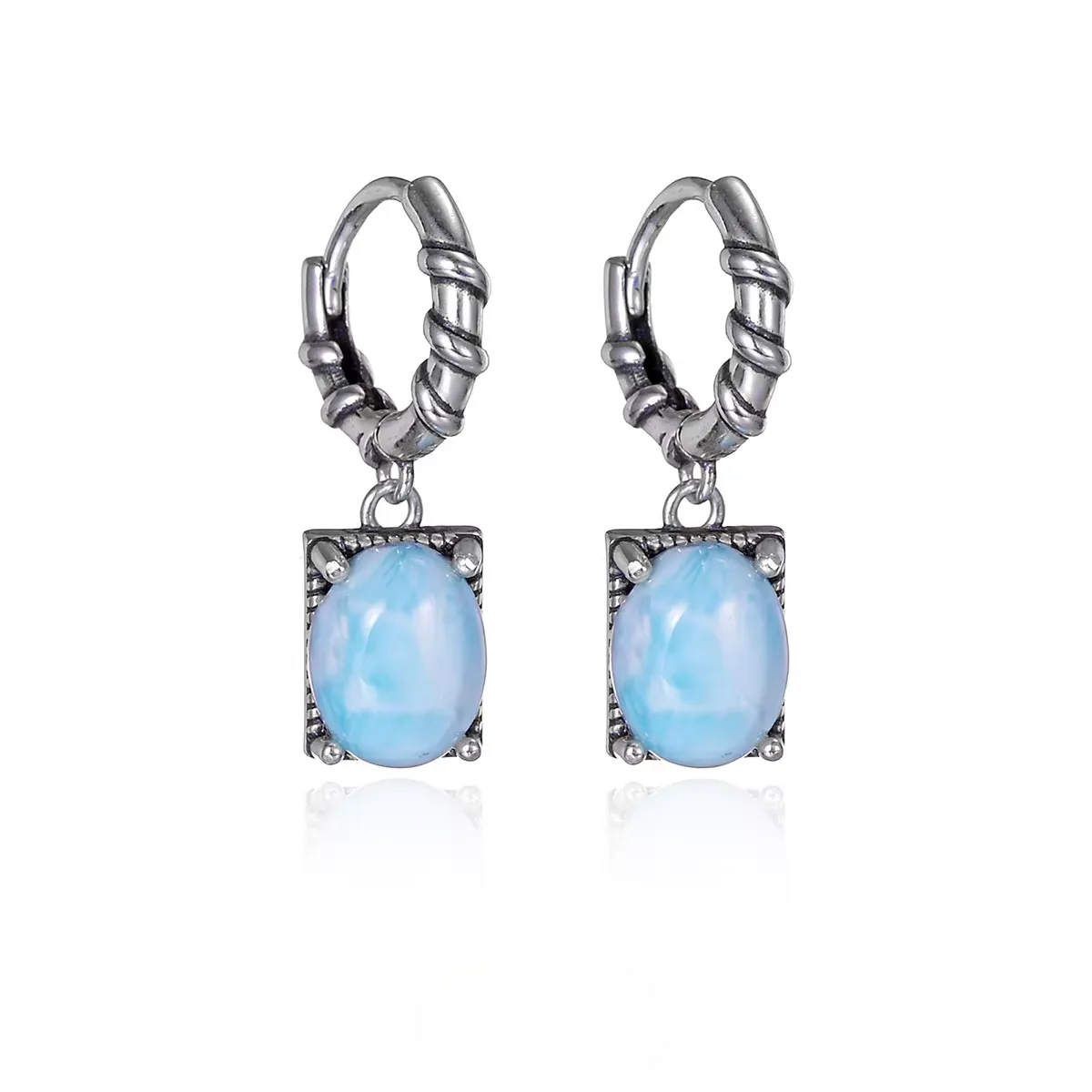 Vintage silver huggie earrings with oval blue larimar stones.