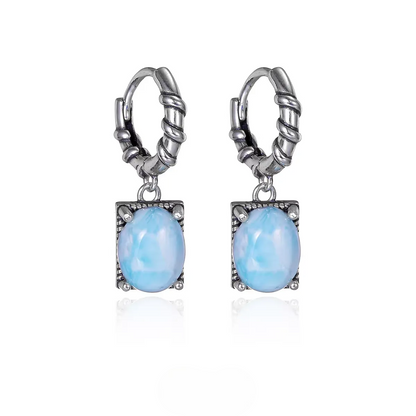 Vintage silver huggie earrings with oval blue larimar stones.