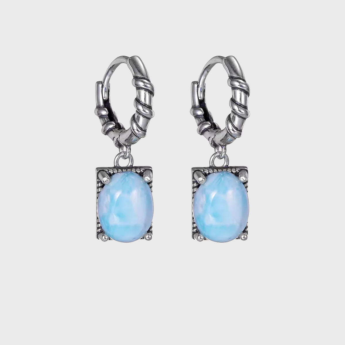 Vintage sterling silver drop earrings with oval light blue Larimar stones.