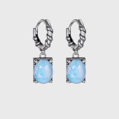 Vintage sterling silver drop earrings with oval light blue Larimar stones.