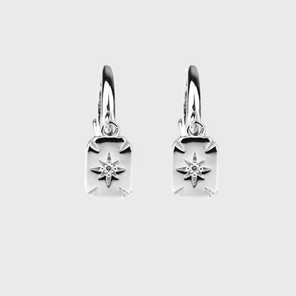Pair of polished silver huggie earrings with rectangular star-design drops.
