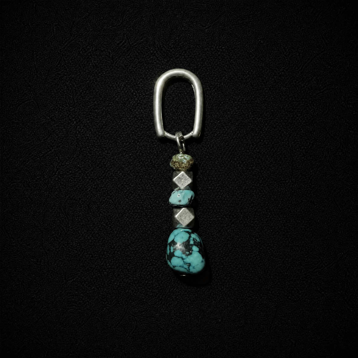 Model wearing a tribal boho S925 silver hoop earring featuring a chunky raw ore turquoise dangle