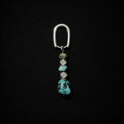 Model wearing a tribal boho S925 silver hoop earring featuring a chunky raw ore turquoise dangle
