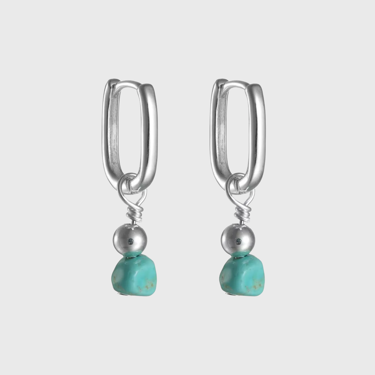 Pair of silver rectangular huggie drop earrings with raw turquoise nuggets.