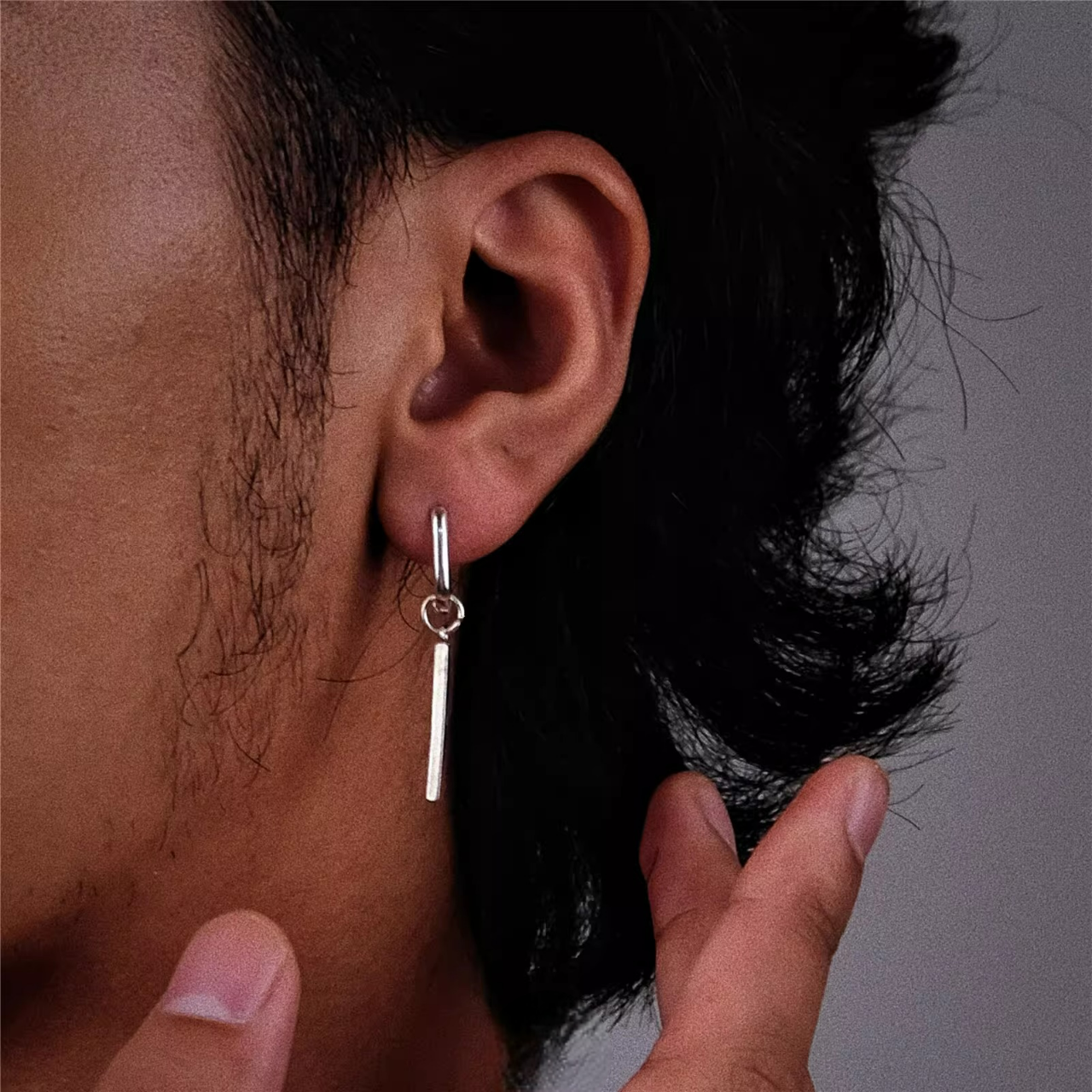 Silver Rectangular Huggie Hoops with Bar Dangle Sleek Geometric Studs worn on ear with minimalist silver bar charm